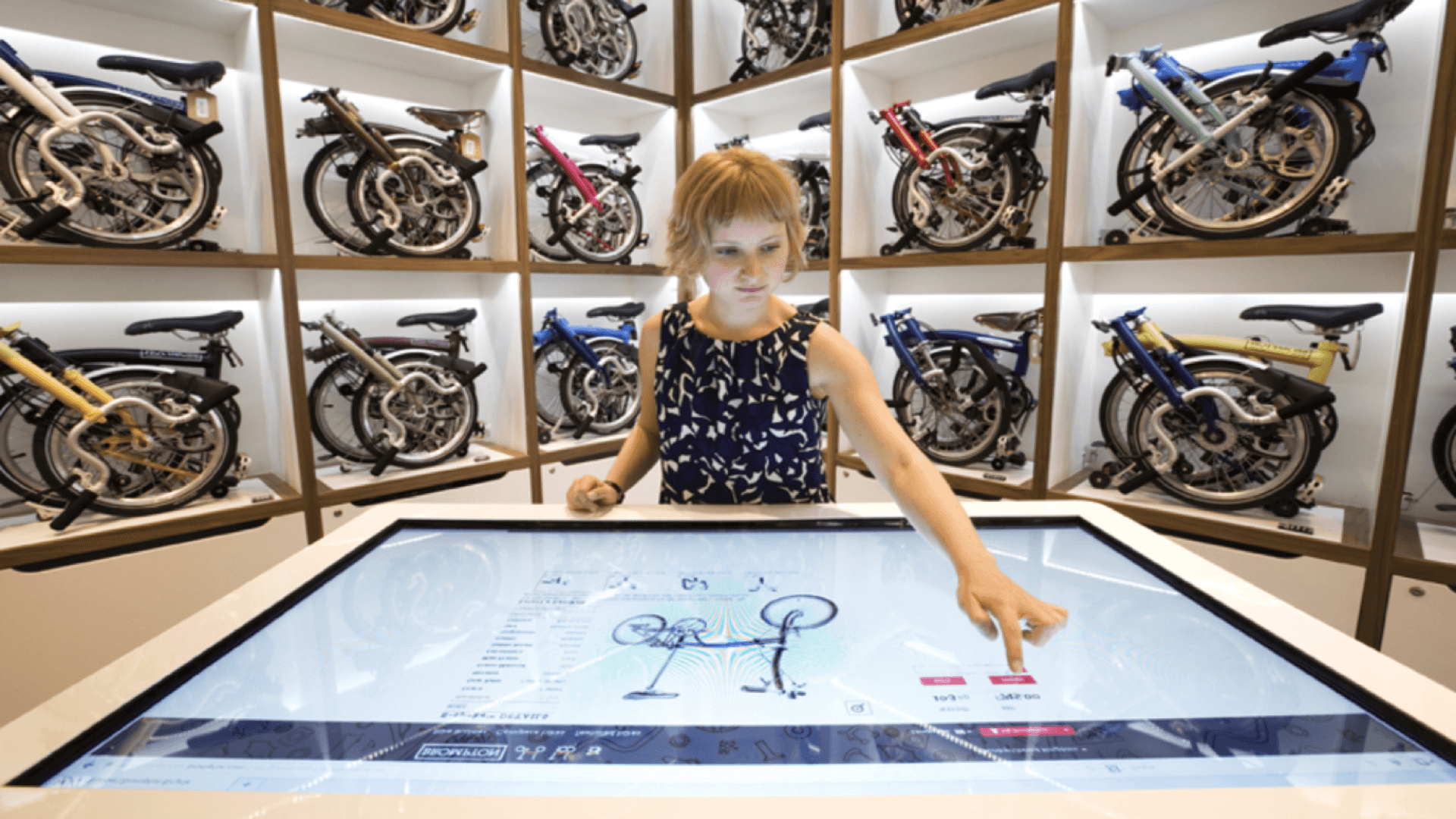 Someone using an in-store bike builder kiosk