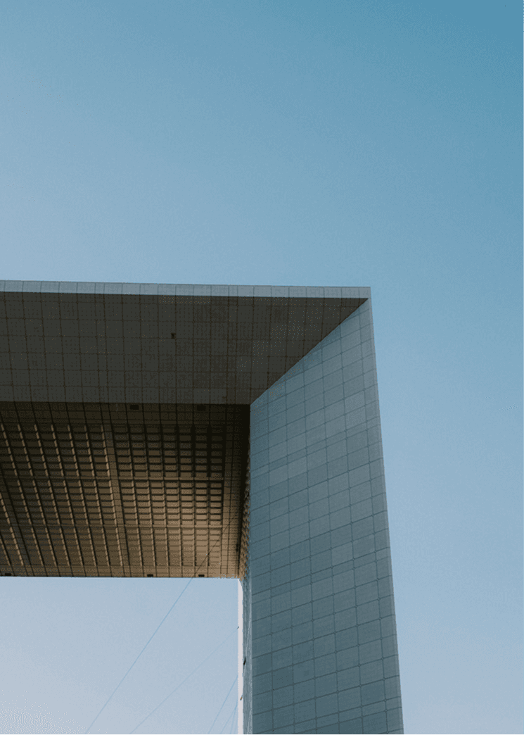 an airplane flying in the sky over a building