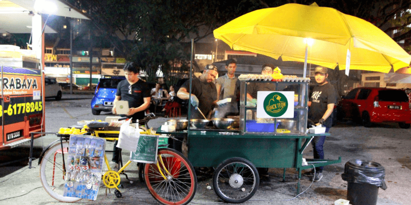 Sekumpulan peniaga F&B menjual char kuey teow atas beca di tepi jalan TTDI, KL.