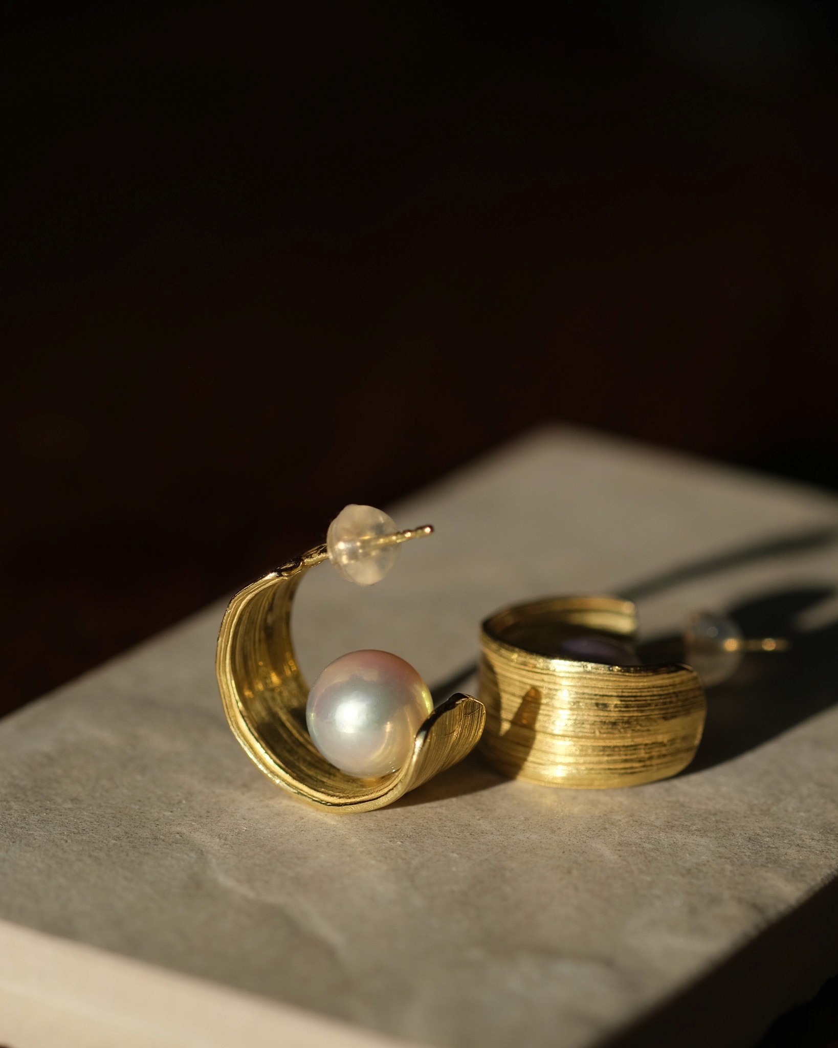 Large gold hoops with an Akoya pearl