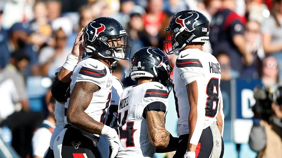 Houston Texans players celebrating during an NFL game on the field.