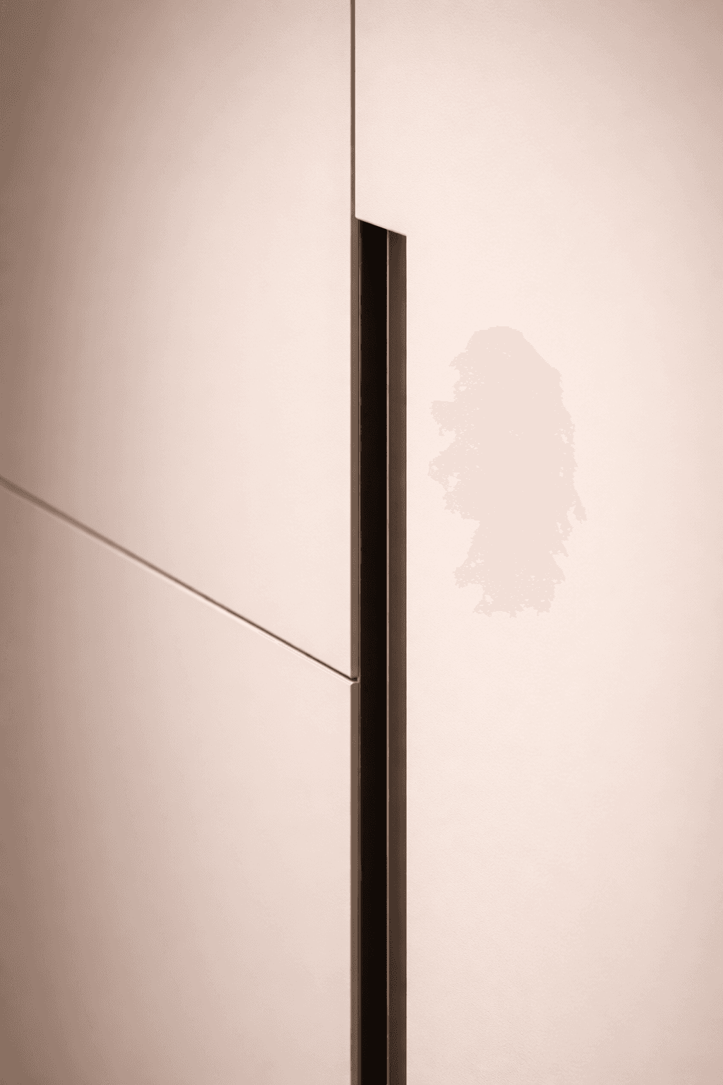 Modern minimalist closet with flush-mounted doors and recessed lighting, integrated into a high-end master suite.