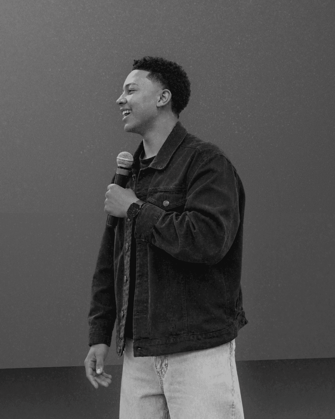 Israel Karuku speaking into a microphone