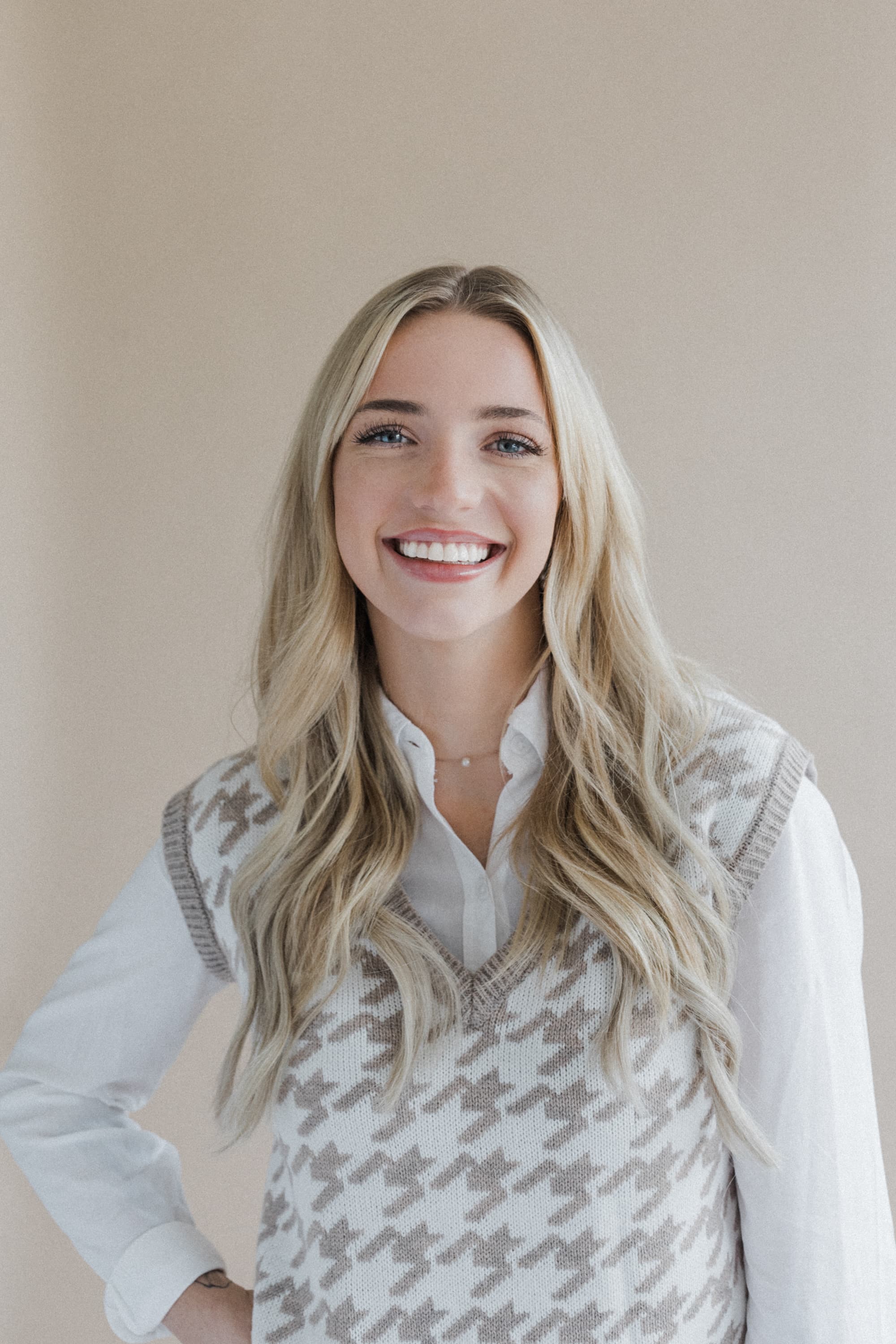 Jade Putch smiling in the naturally lit Revelator Studio, a photography studio in Shreveport that offers a professional and modern environment for creative projects.