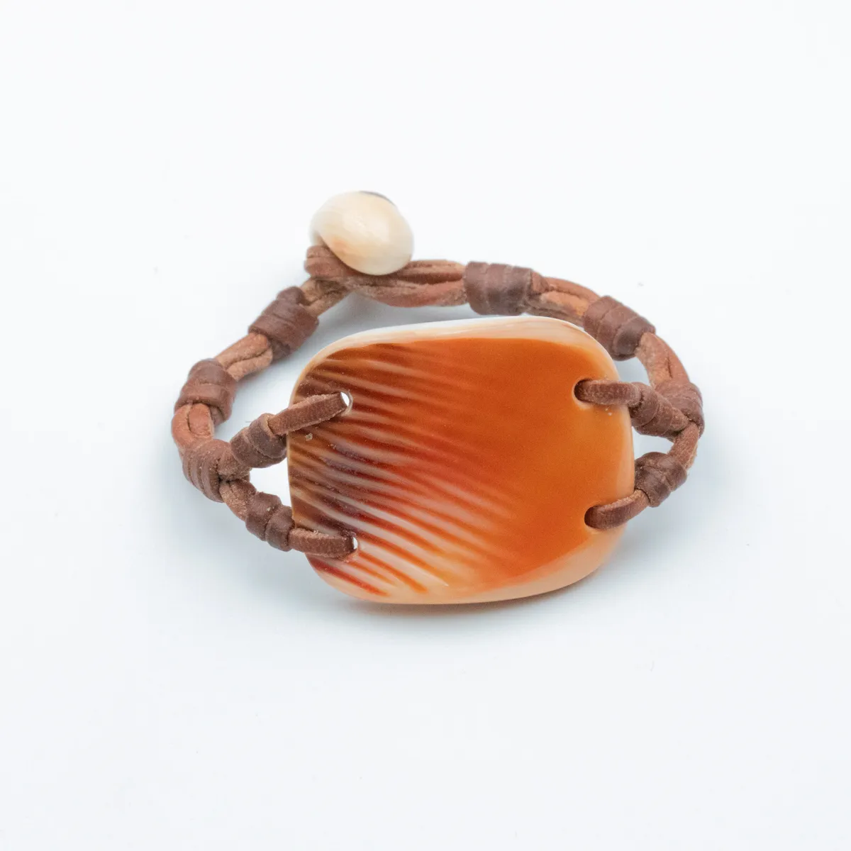 Amber ridged Seashell bracelet with cream shell closure on rust and brown hand-knotted leather cord — Manos de Oro Saint Barth