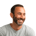 man in grey blazer near green trees during daytime