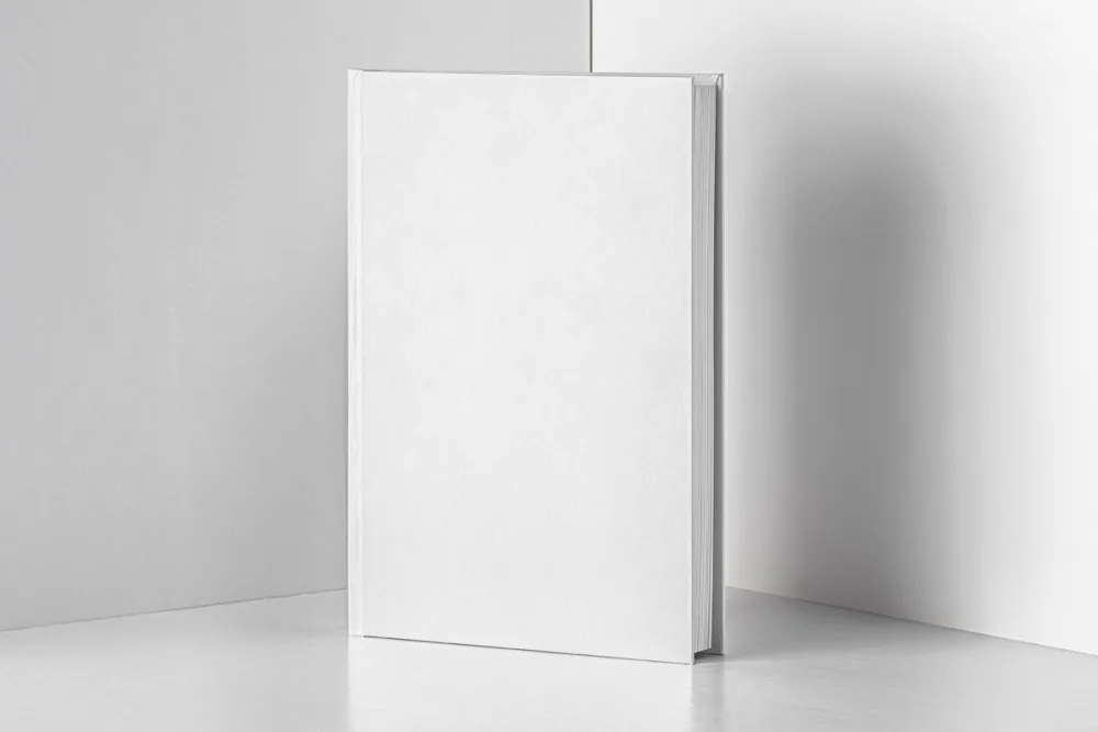 Hardcover book mockup in an upright position featuring a geometric green and black cover design with pink text. Displayed against a split black and pink background for a bold, modern aesthetic.