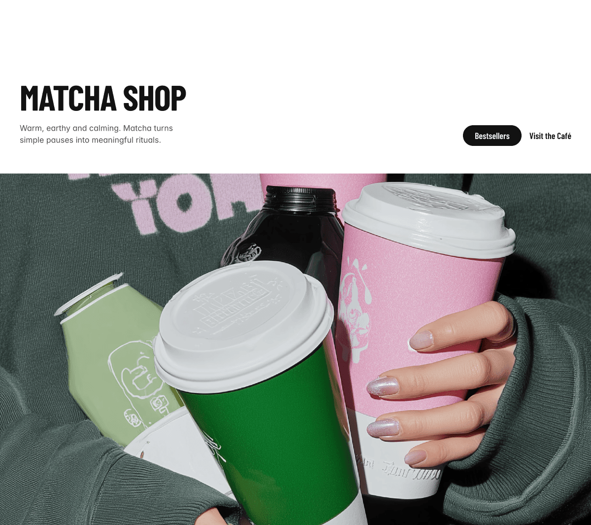 Modern matcha shop website hero design featuring colorful takeaway cups in green and pink