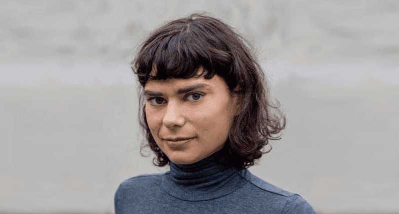 A photo of a woman wearing a blue blouse.