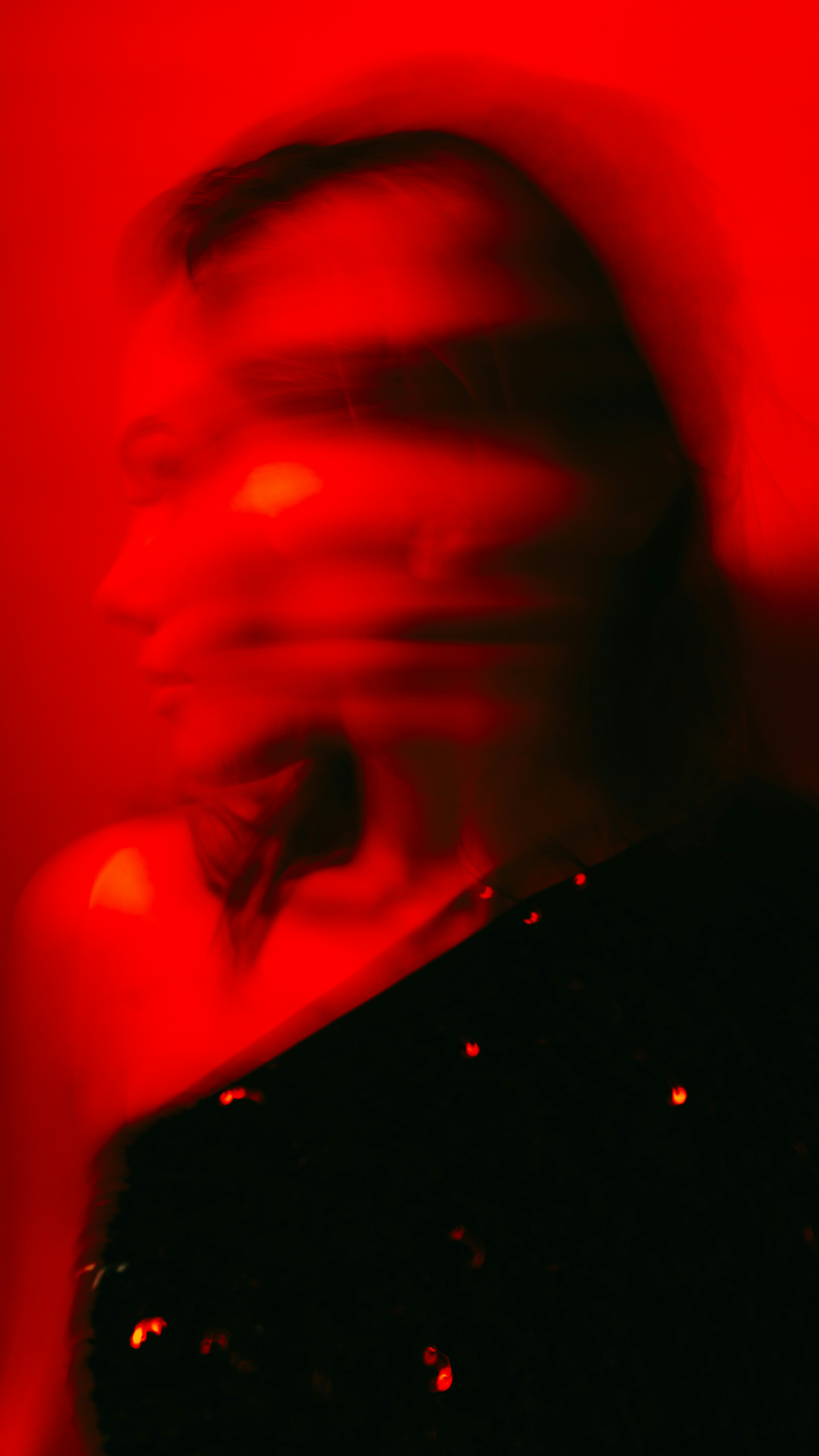 A blurry photo of a woman in a black dress