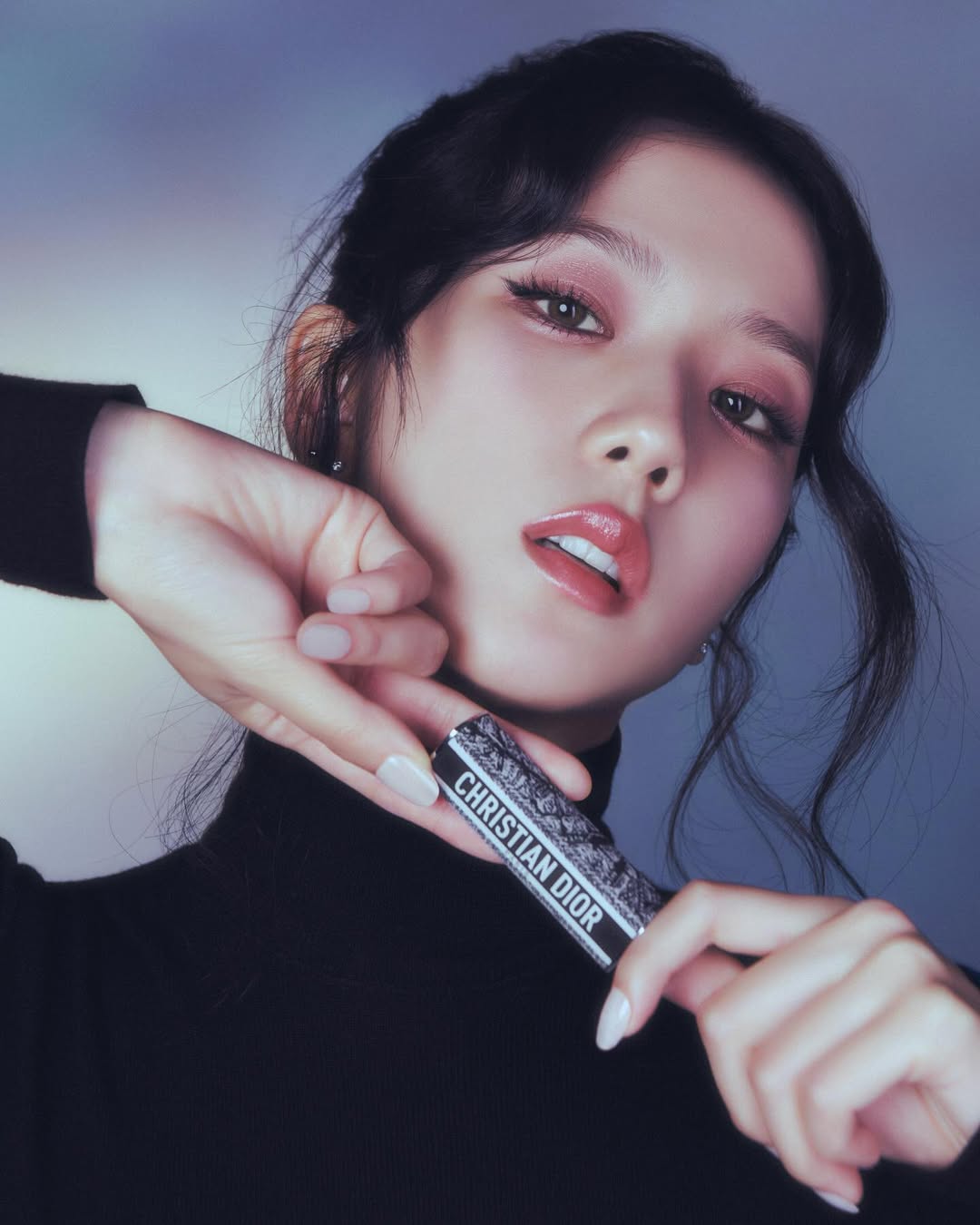 Jisoo of BLACKPINK holding a Dior lipstick in front of her face, wearing glossy coral lips and soft eye makeup for Dior Beauty in Marie Claire Korea.
