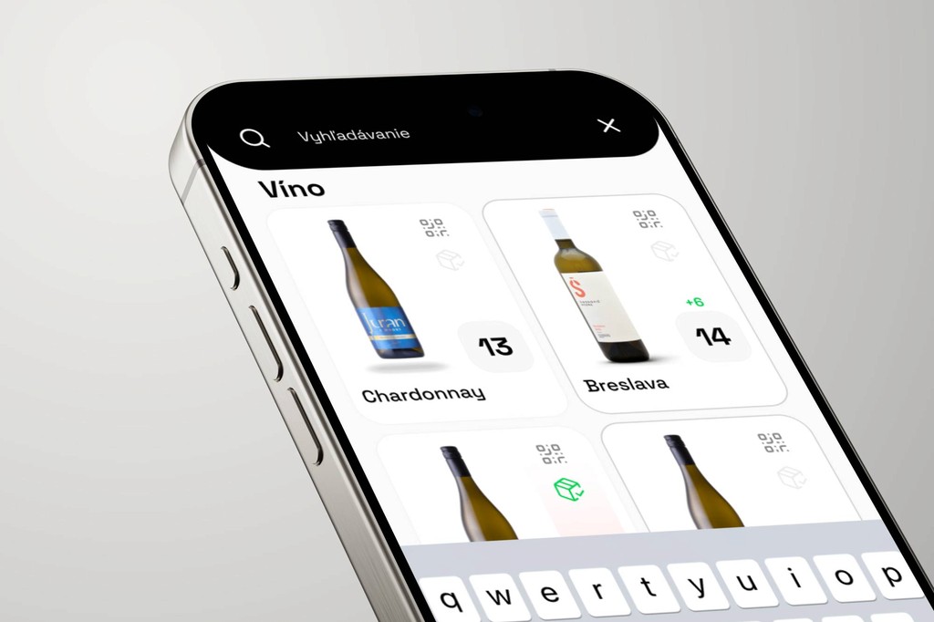 Close-up of a smartphone screen displaying a wine selection app with a search bar at the top, showing Chardonnay and Breslava wine bottles along with their respective stock numbers in a minimalist white interface.