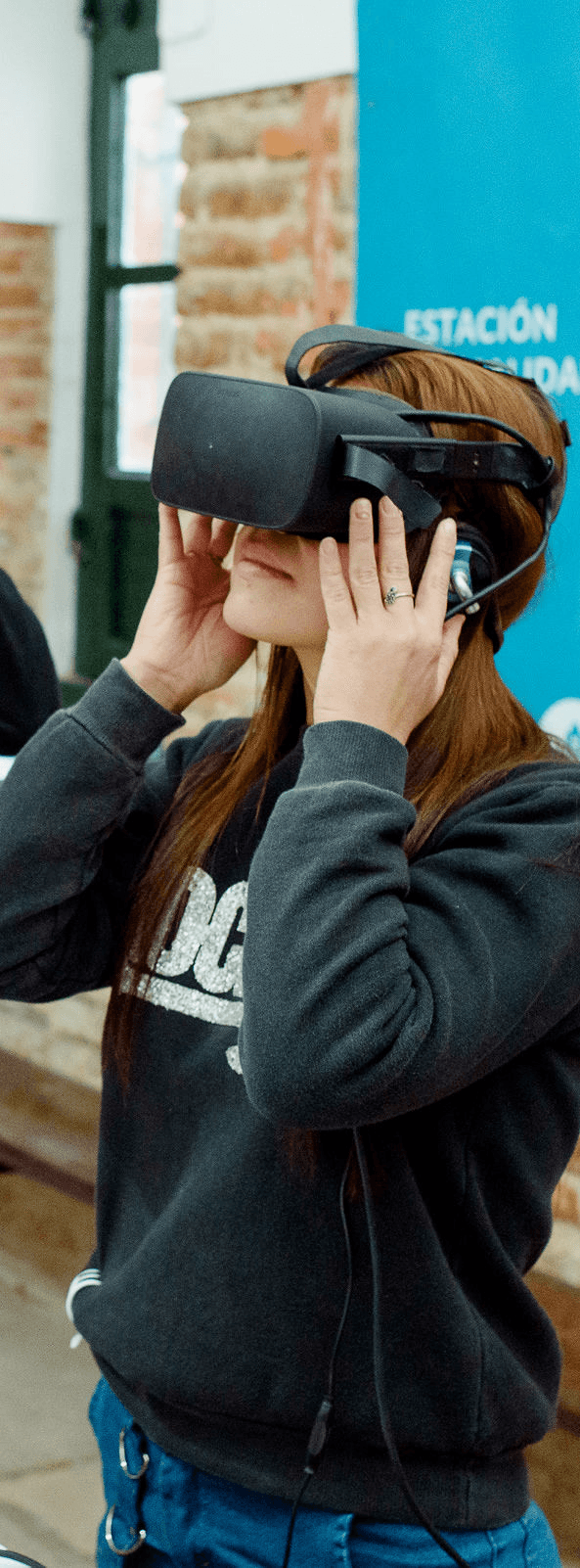 Portrait of a person in dark clothing speaking on a phone