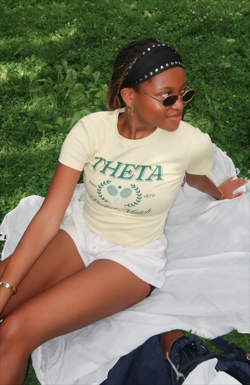 Alex Ruff styling a fitted Theta sorority baby tee as a casual athletic outfit.