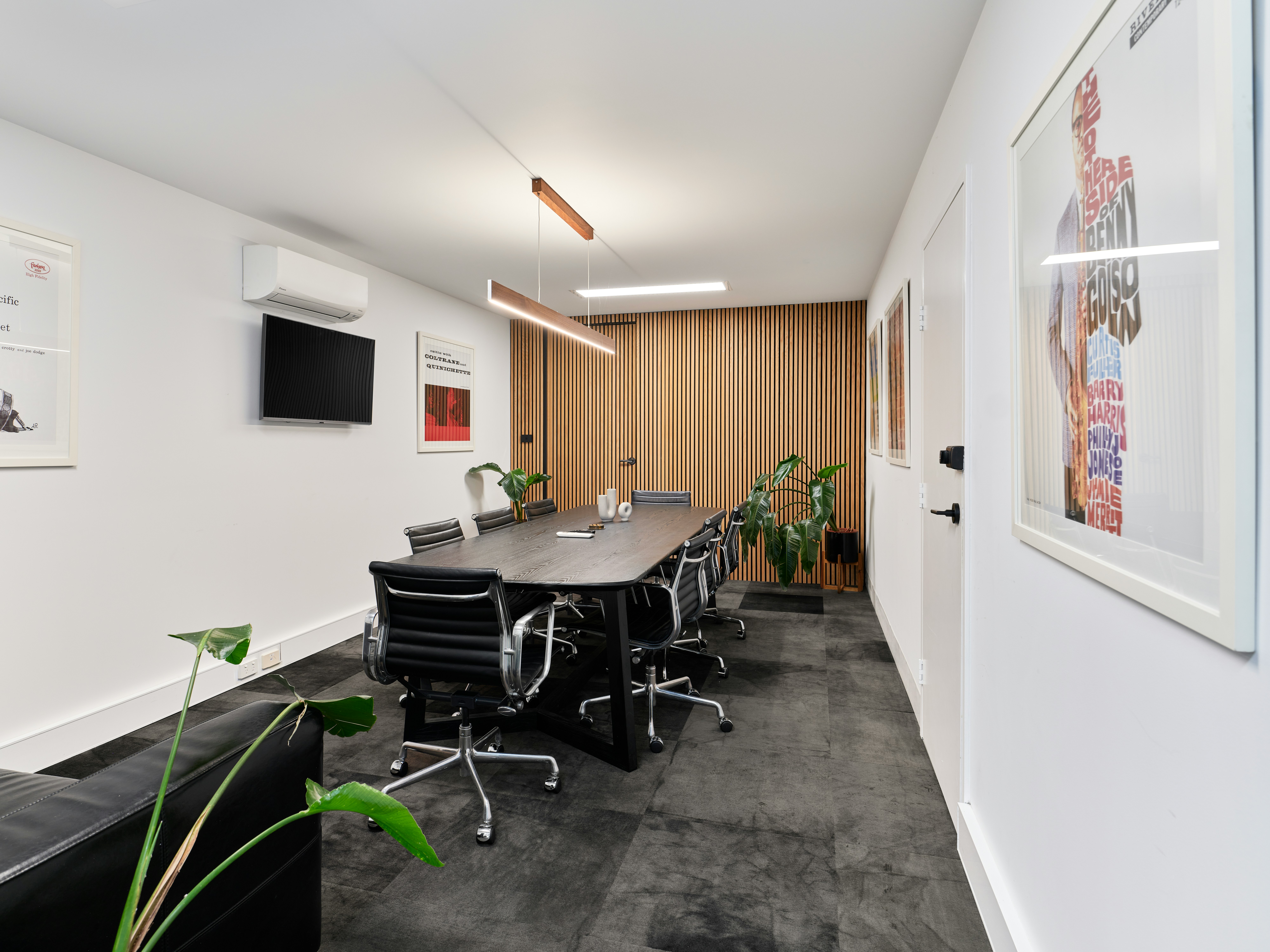 A hand arranging wooden blocks with environmental icons like recycling and wind power to represent aligning an office refurbishment with ESG principles.
