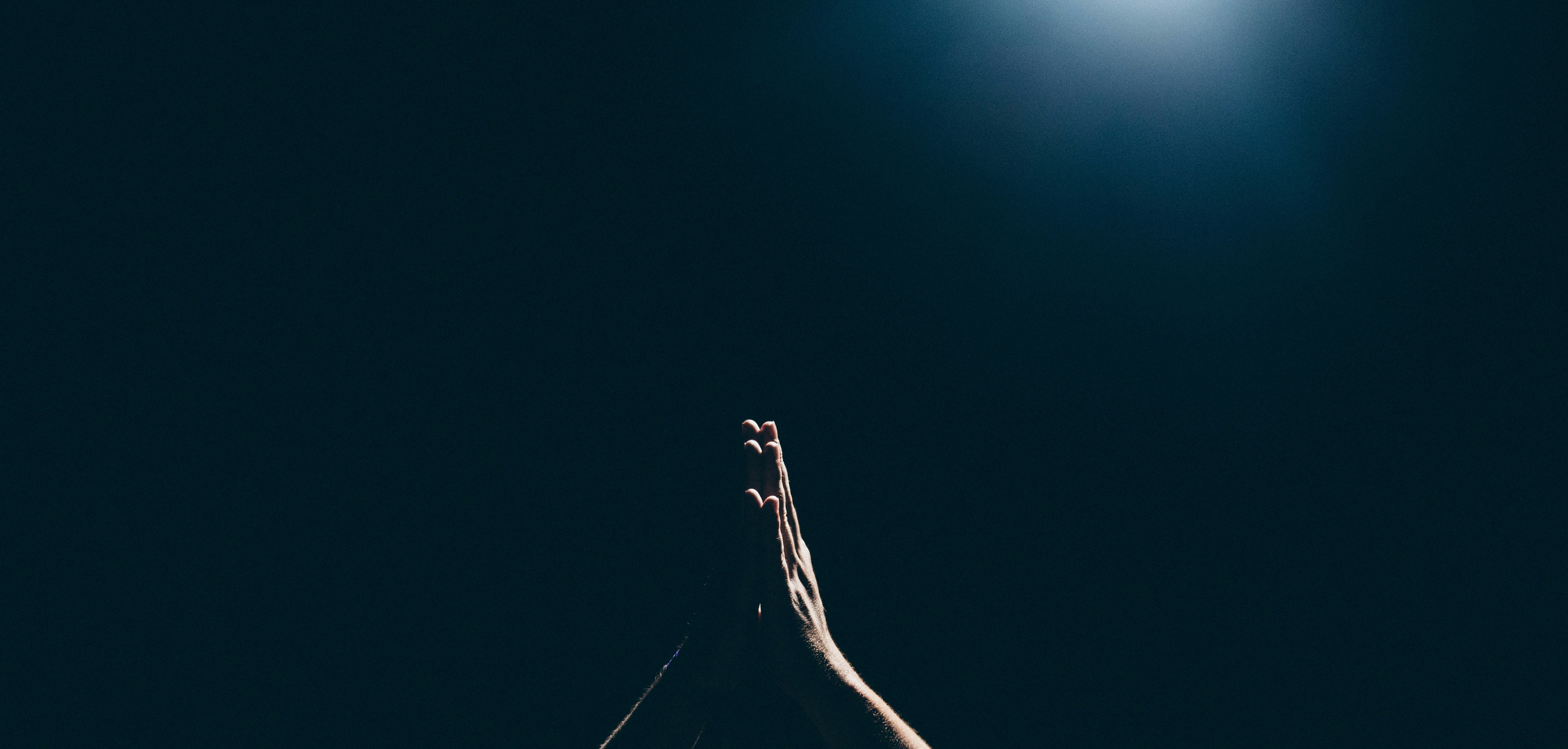 person hand in praying position - how to write gospel songs