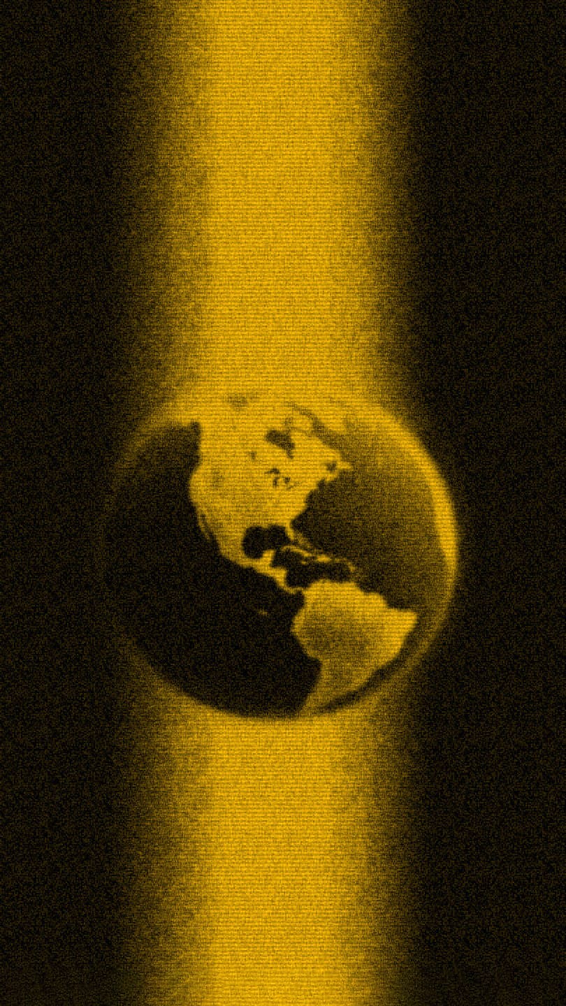 golden energy beam illuminating a globe emerging from darknes