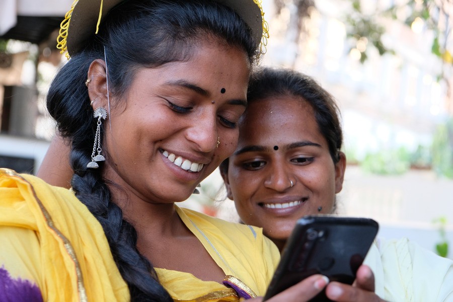 Indian women looking at a phone