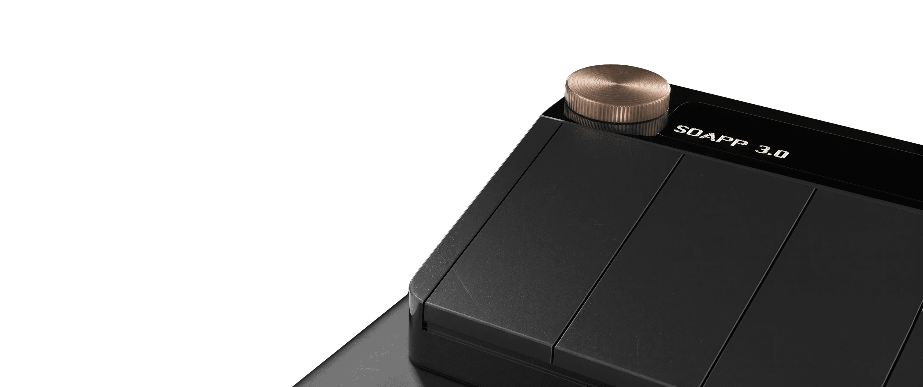 Three quarter view of the Riff MIDI Link in a matte black finish with a brass rotary knob and a black display showing the white text “SOAPP 3.0” on a transparent background.