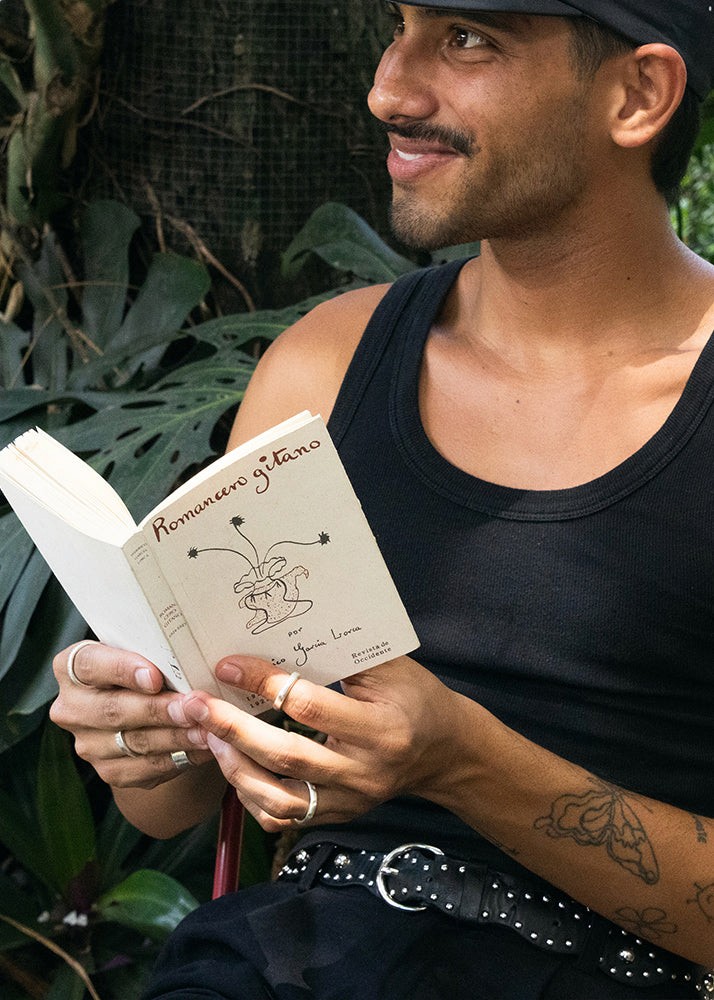 men reading a book, wearing silver rings