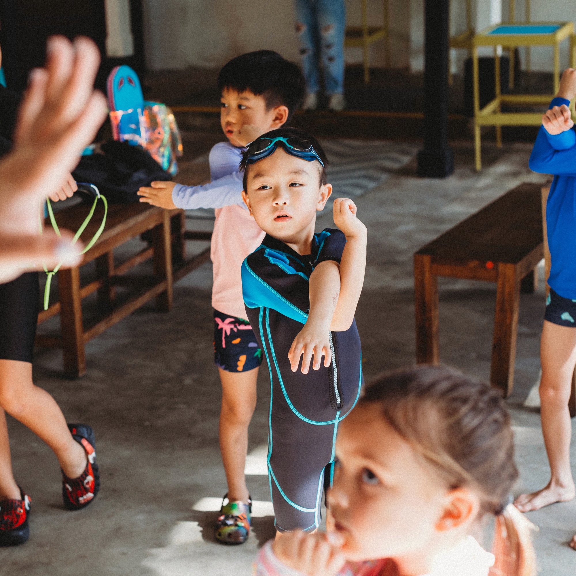 Children doing a group warm-up on deck before swimming at a Swish holiday camp
