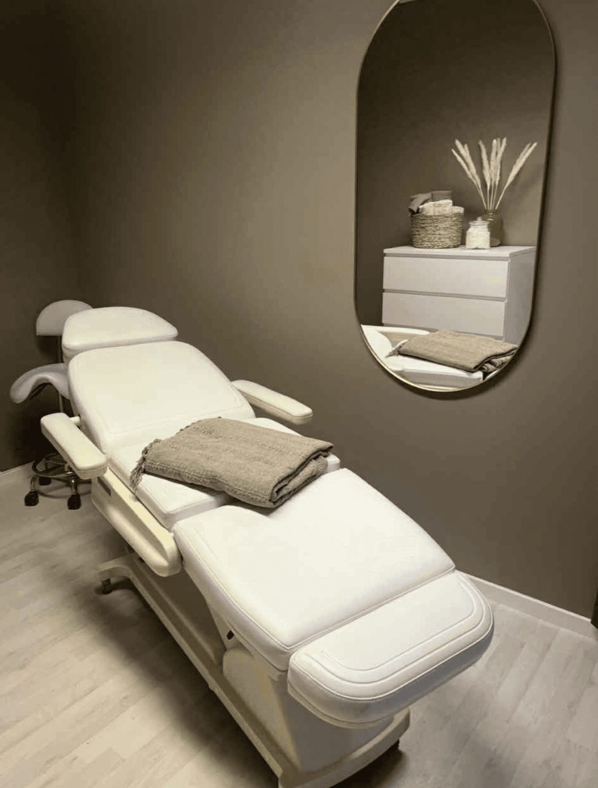 Modern aesthetic clinic treatment chair in beige minimalist interior