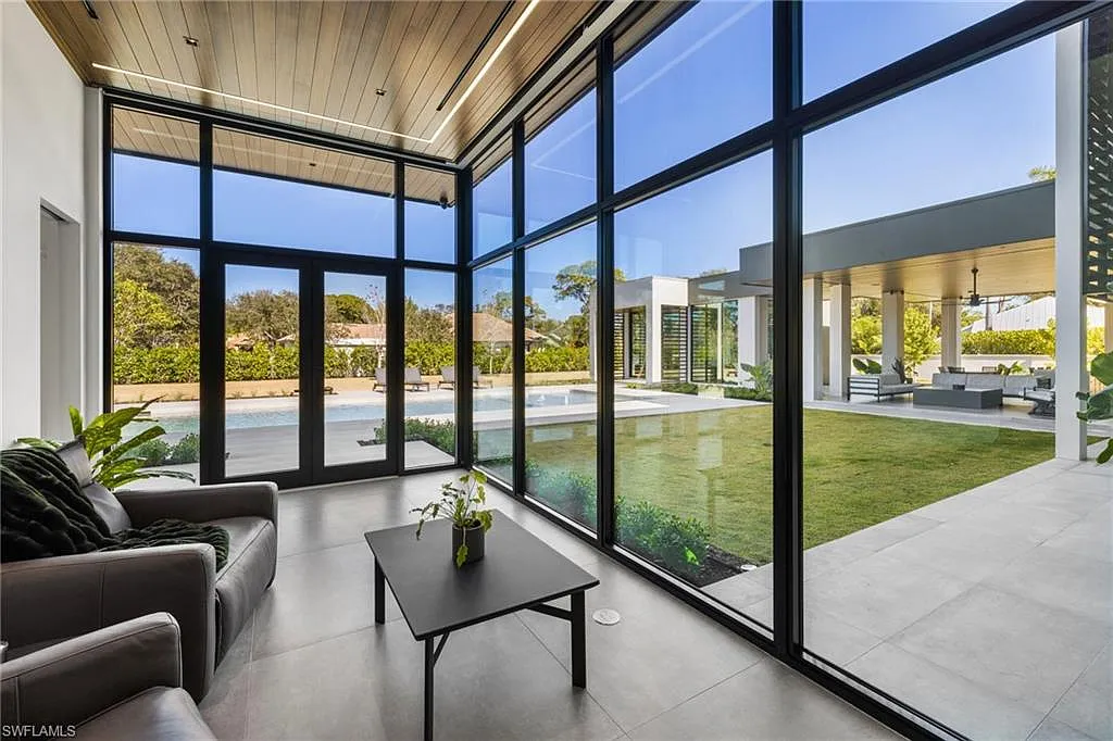 Seating area framed by expansive floor-to-ceiling windows
