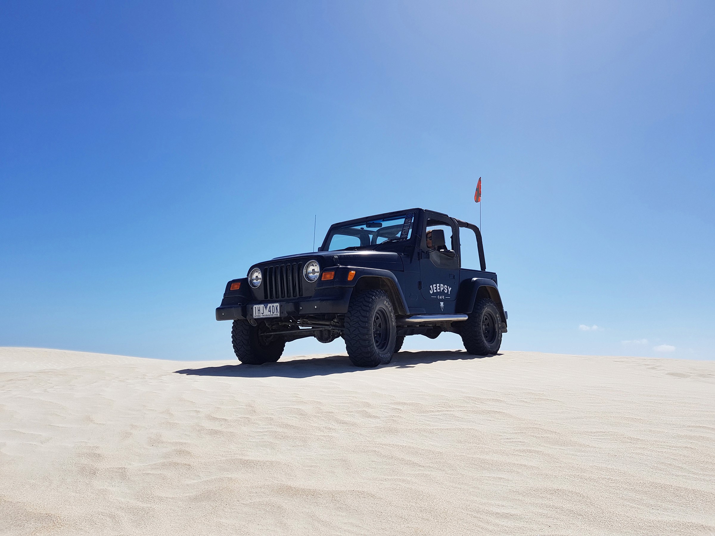Dynamic picture of Jeep Wrangler on sand dunes