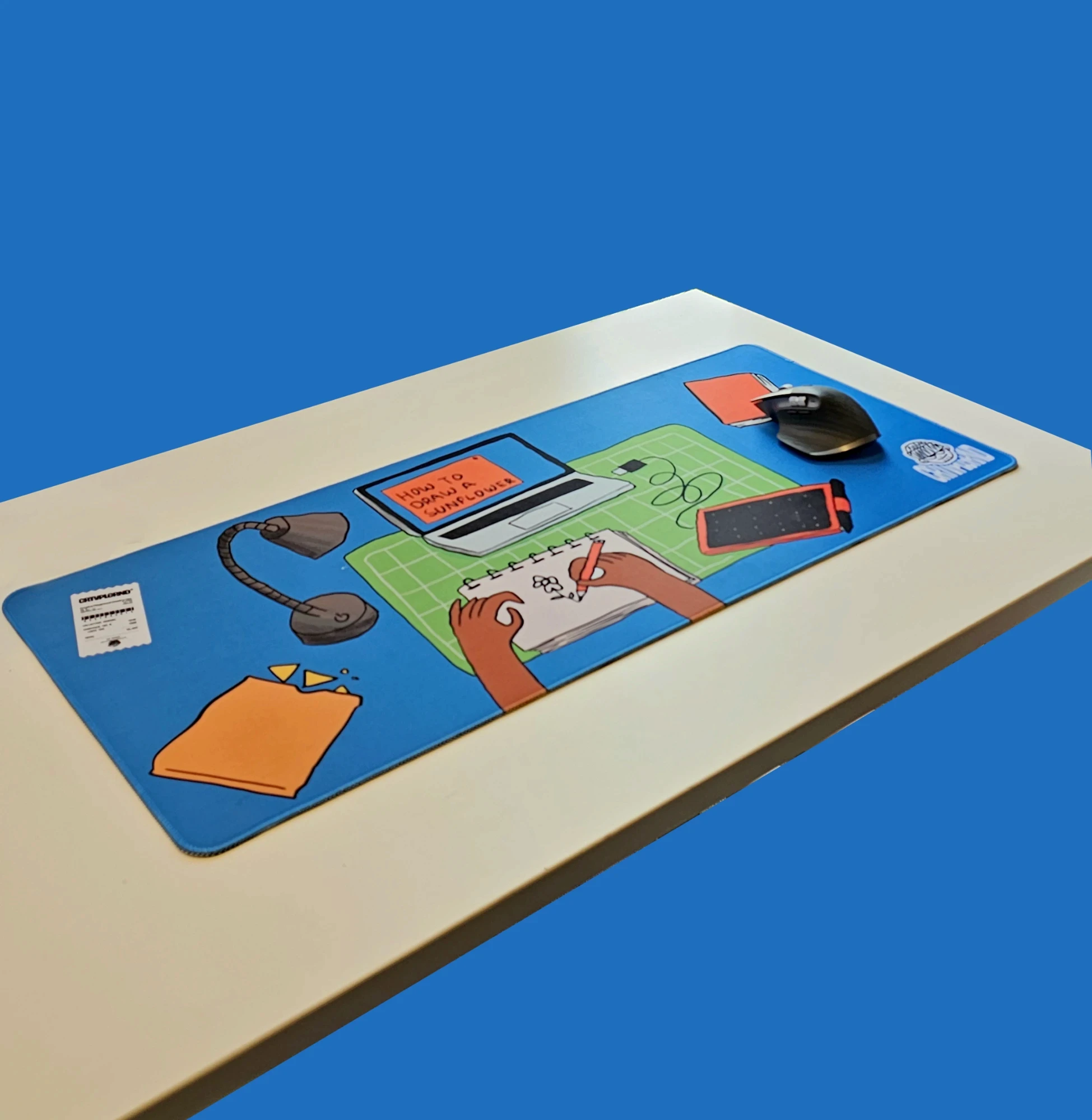 Messy Deskmat on a white desk against a blue background