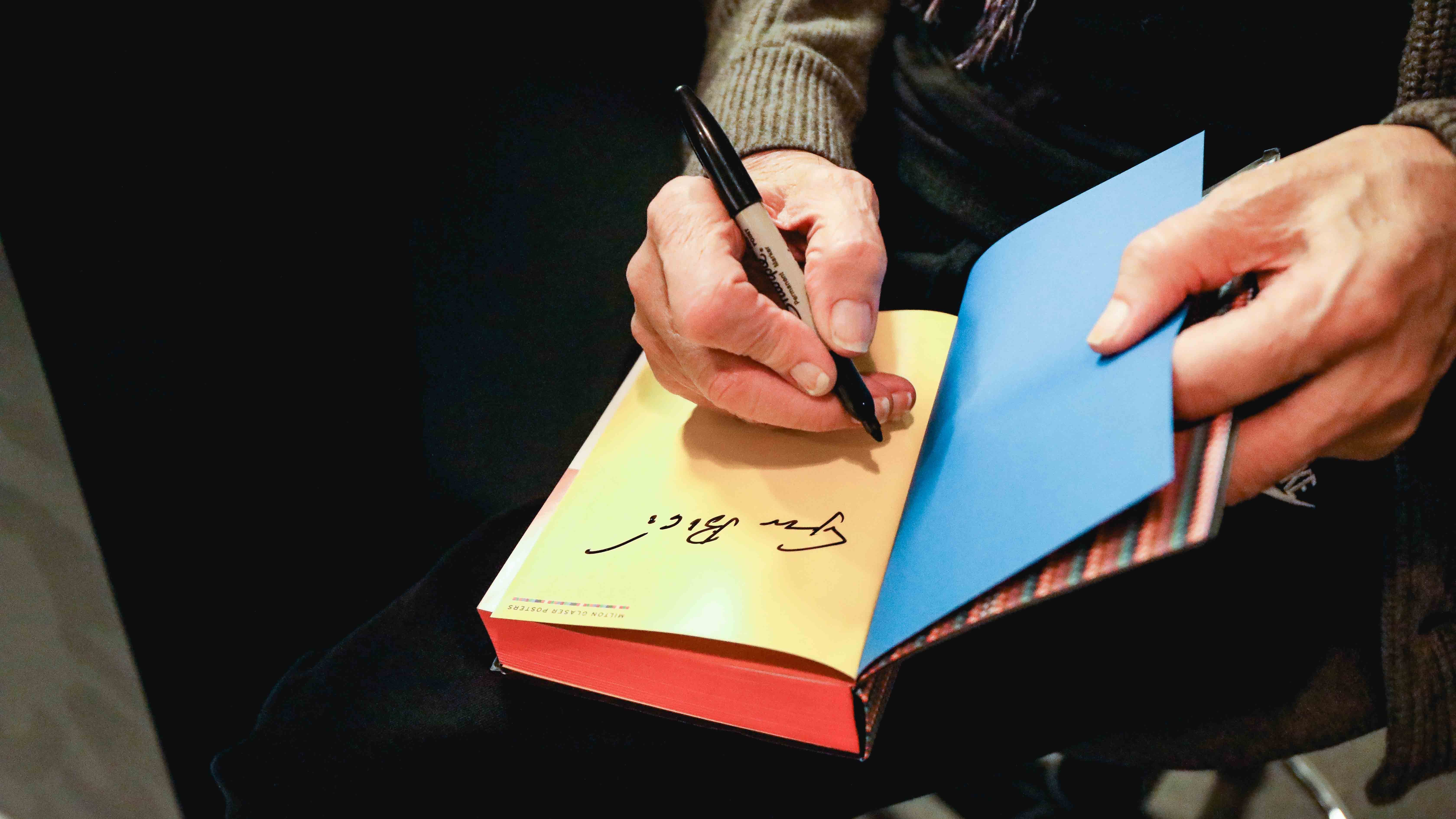 Milton signing a book
