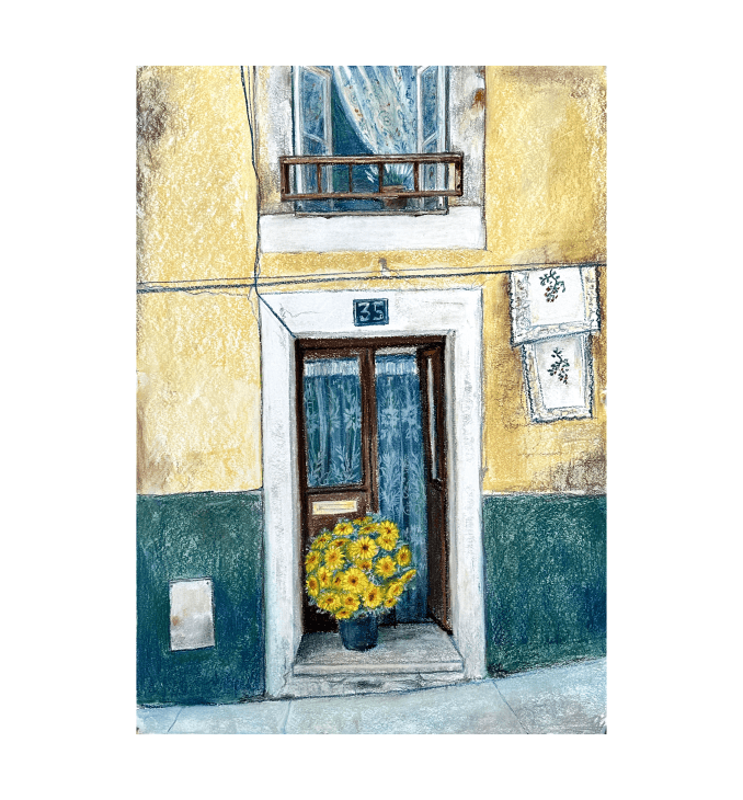 a yellow flower pot in front of a building