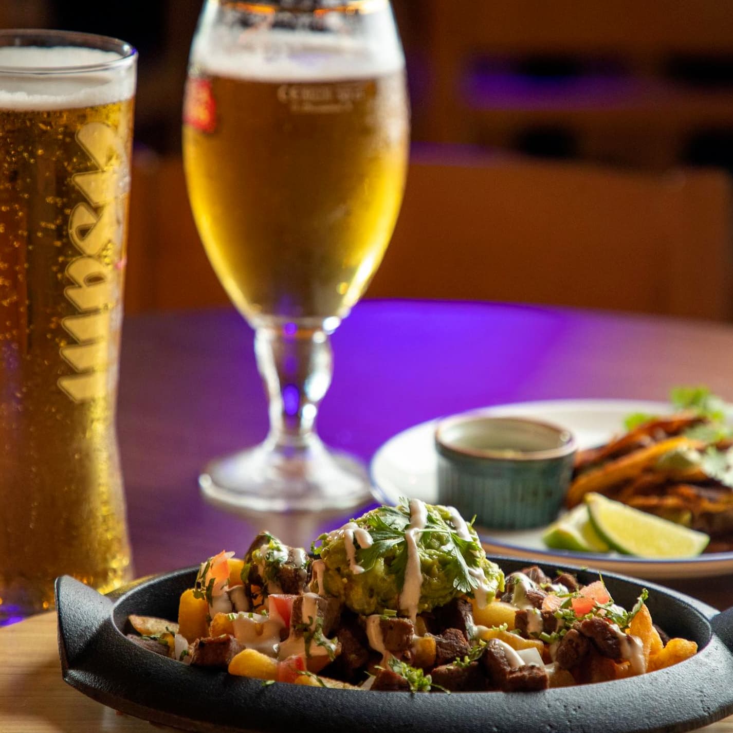 Happy hour Dubai with chilled beer pairing perfectly with Mexican food and tacos.