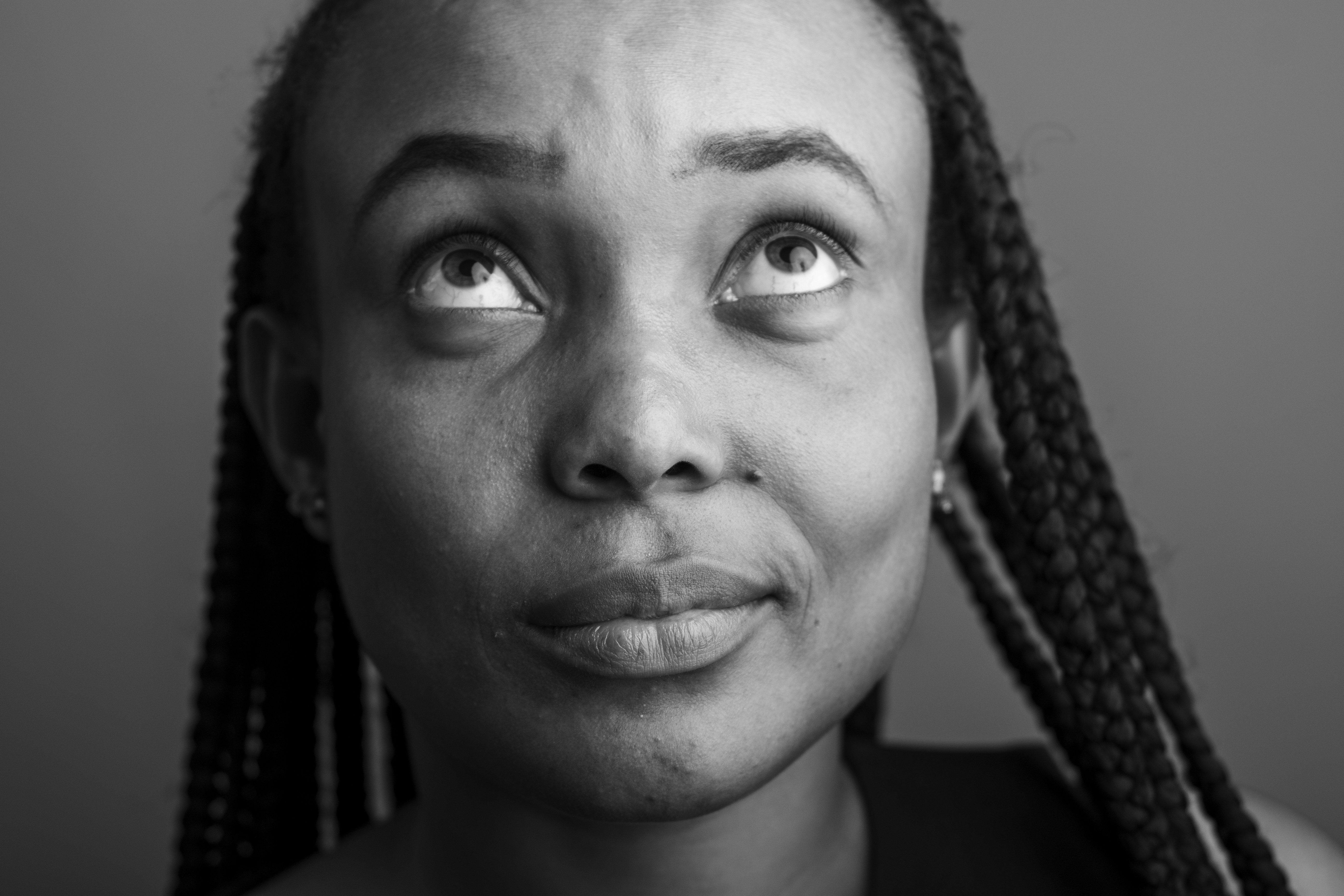 a black and white photo of a woman with braids