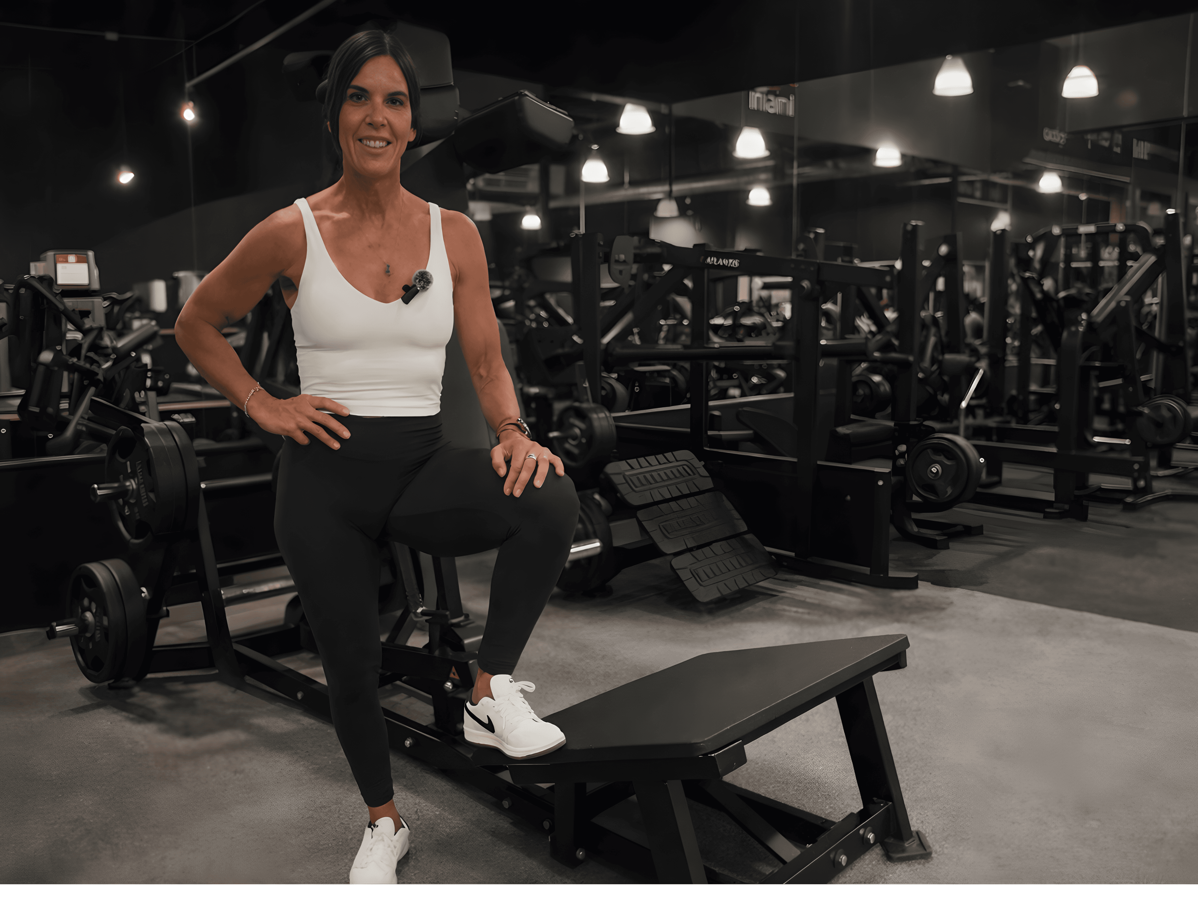 Dustie Samson, personal trainer, looking to the side confidently in a fitness studio