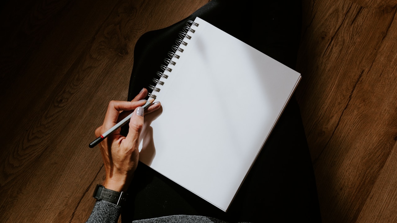 Person journaling for self-reflection and mental health mindfulness | Photo by Kelly Sikkema on Unsplash