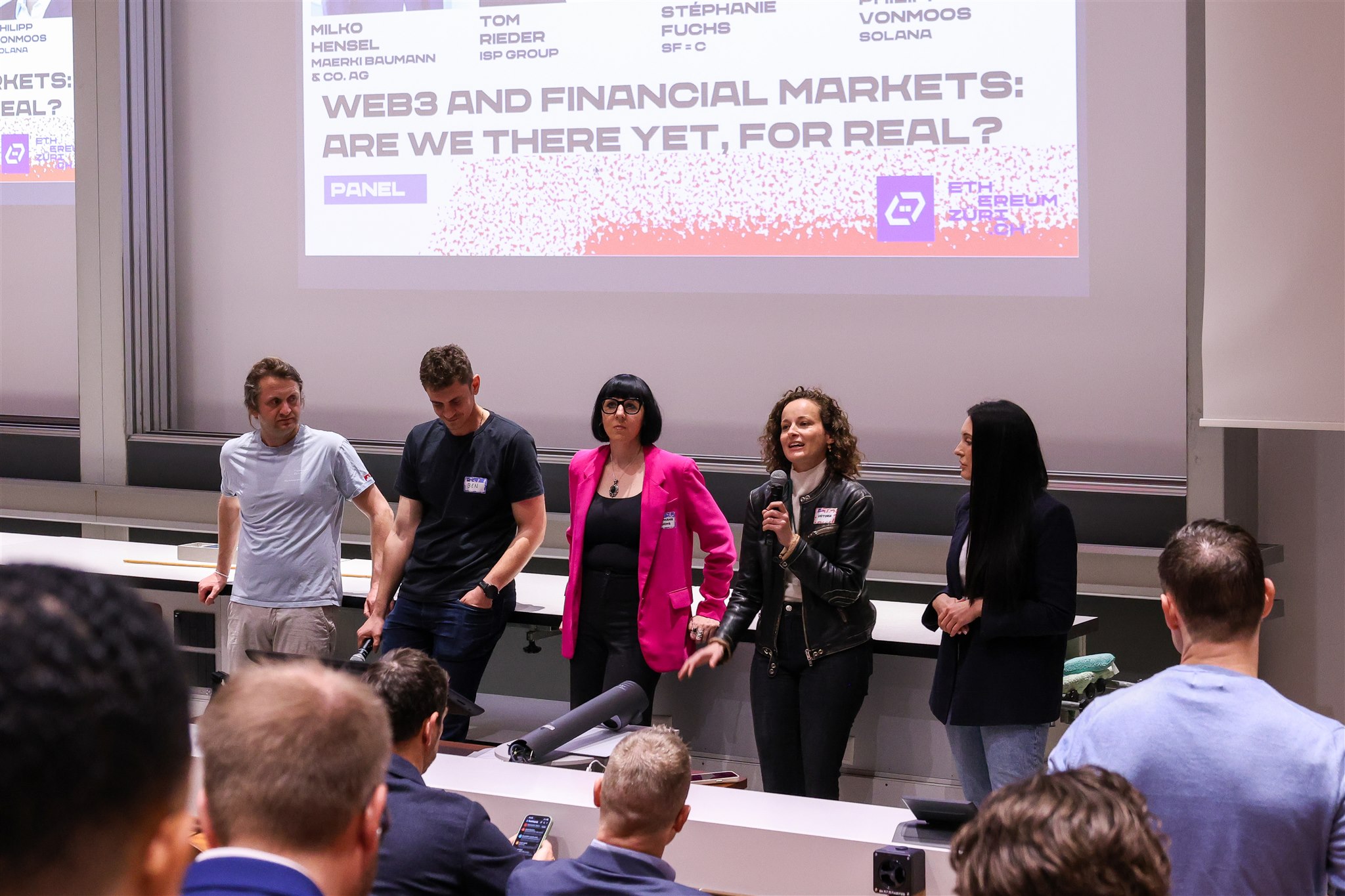 Panel discussion on stage during EthereumZüri conference in Zurich