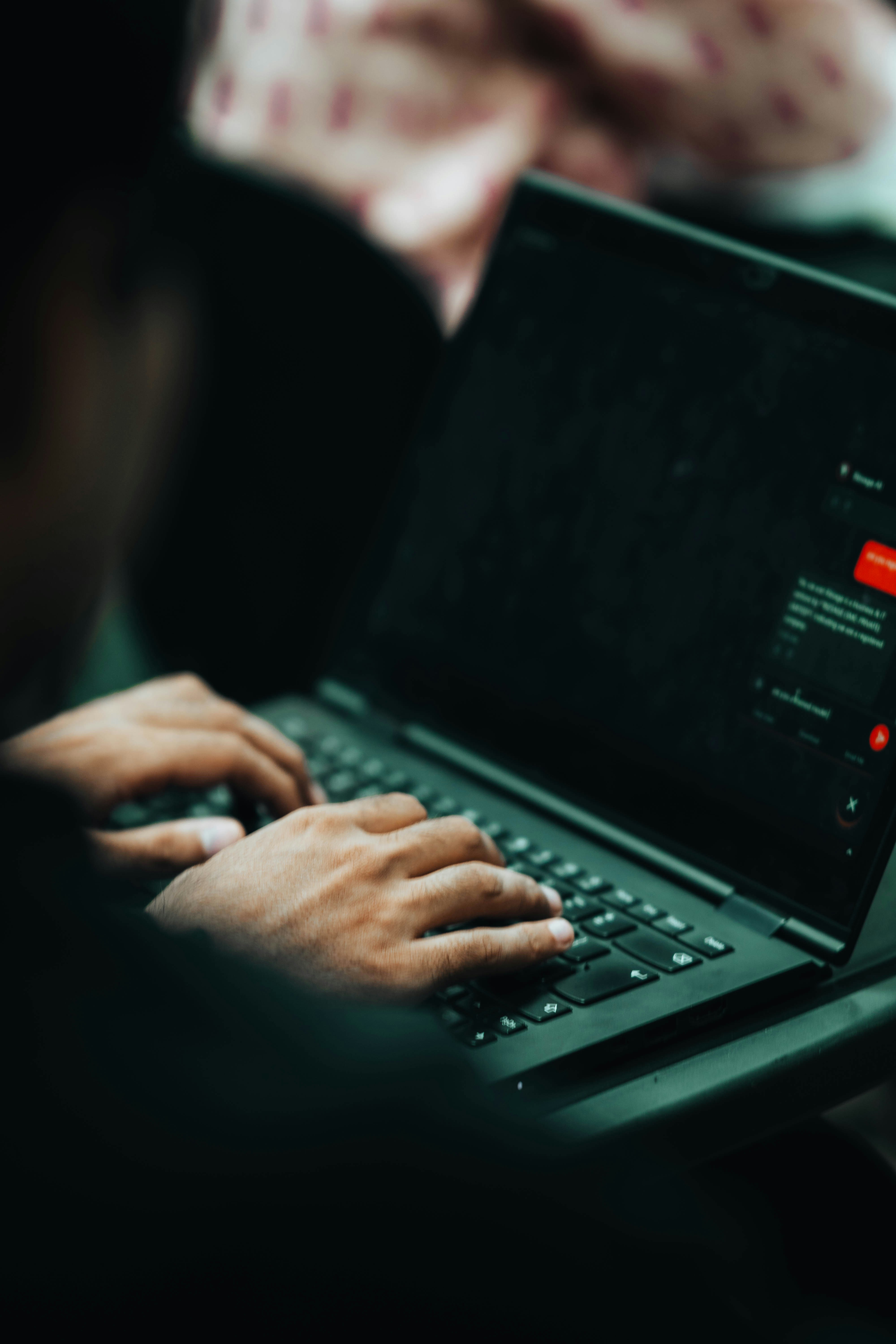 Someone is typing on a laptop keyboard.