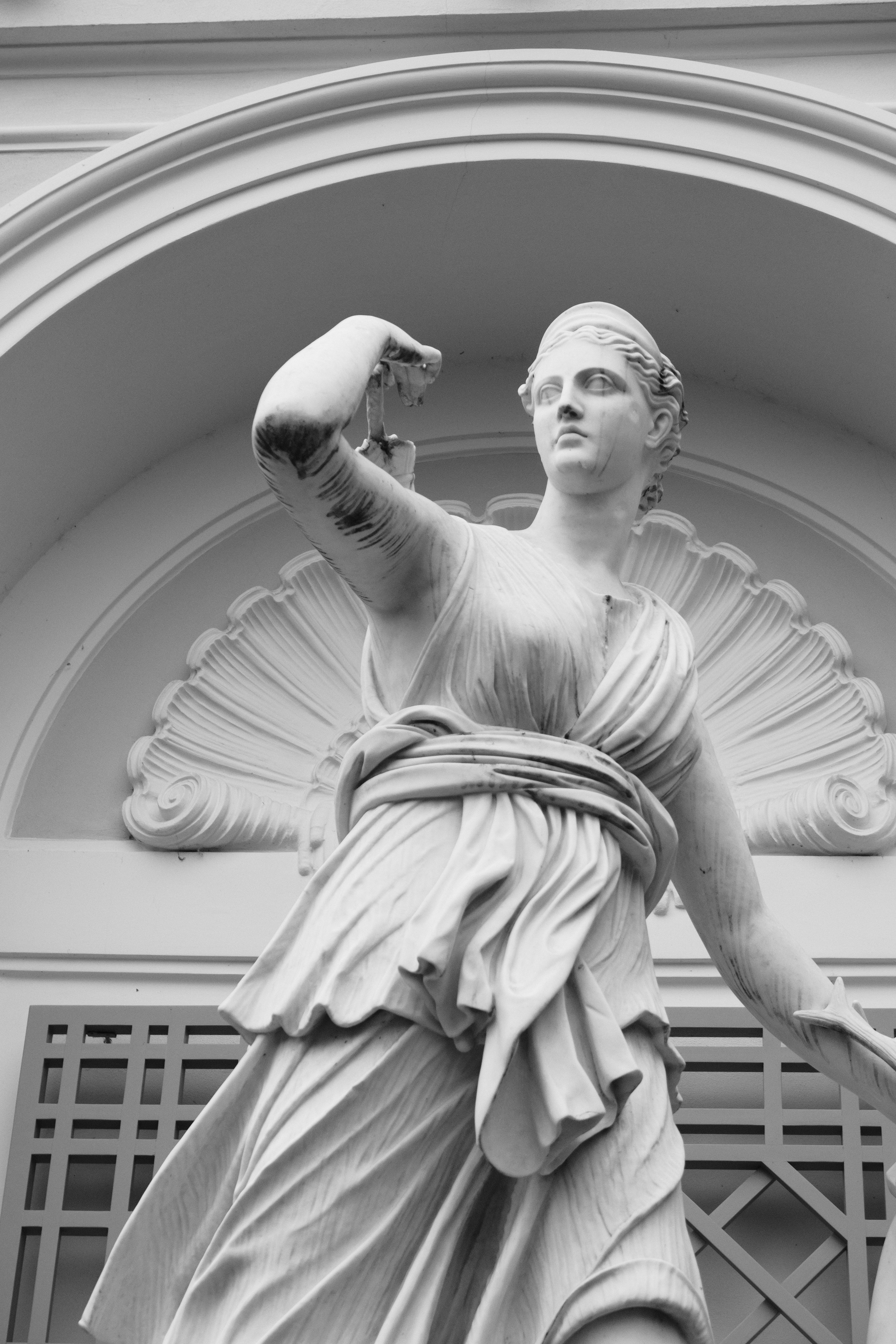 a statue of a woman holding a bird in her hand