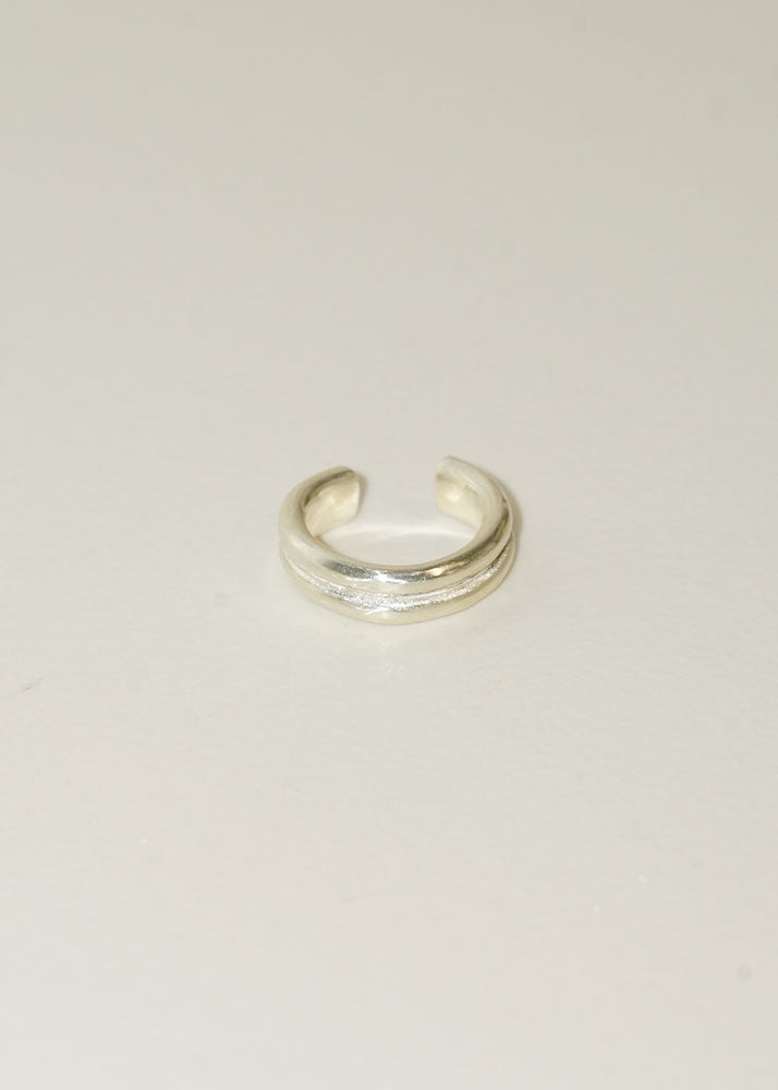 Silver ring on a light beige background