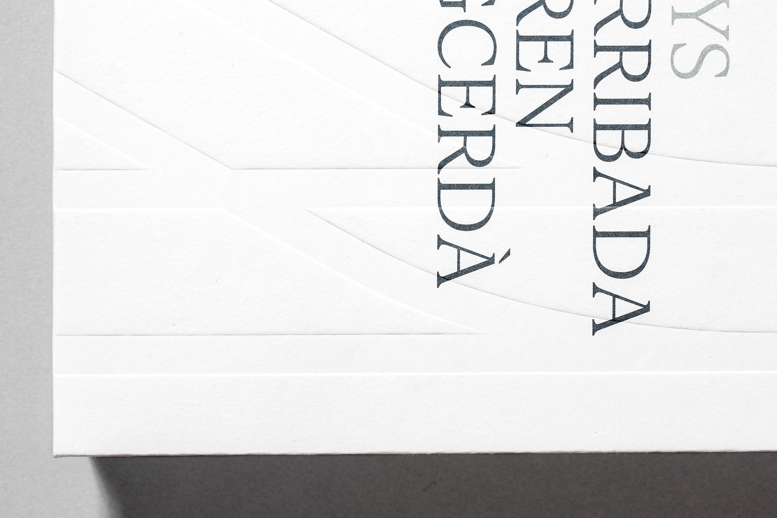 Stack of modern books and magazine with minimalist cover design on leather chair