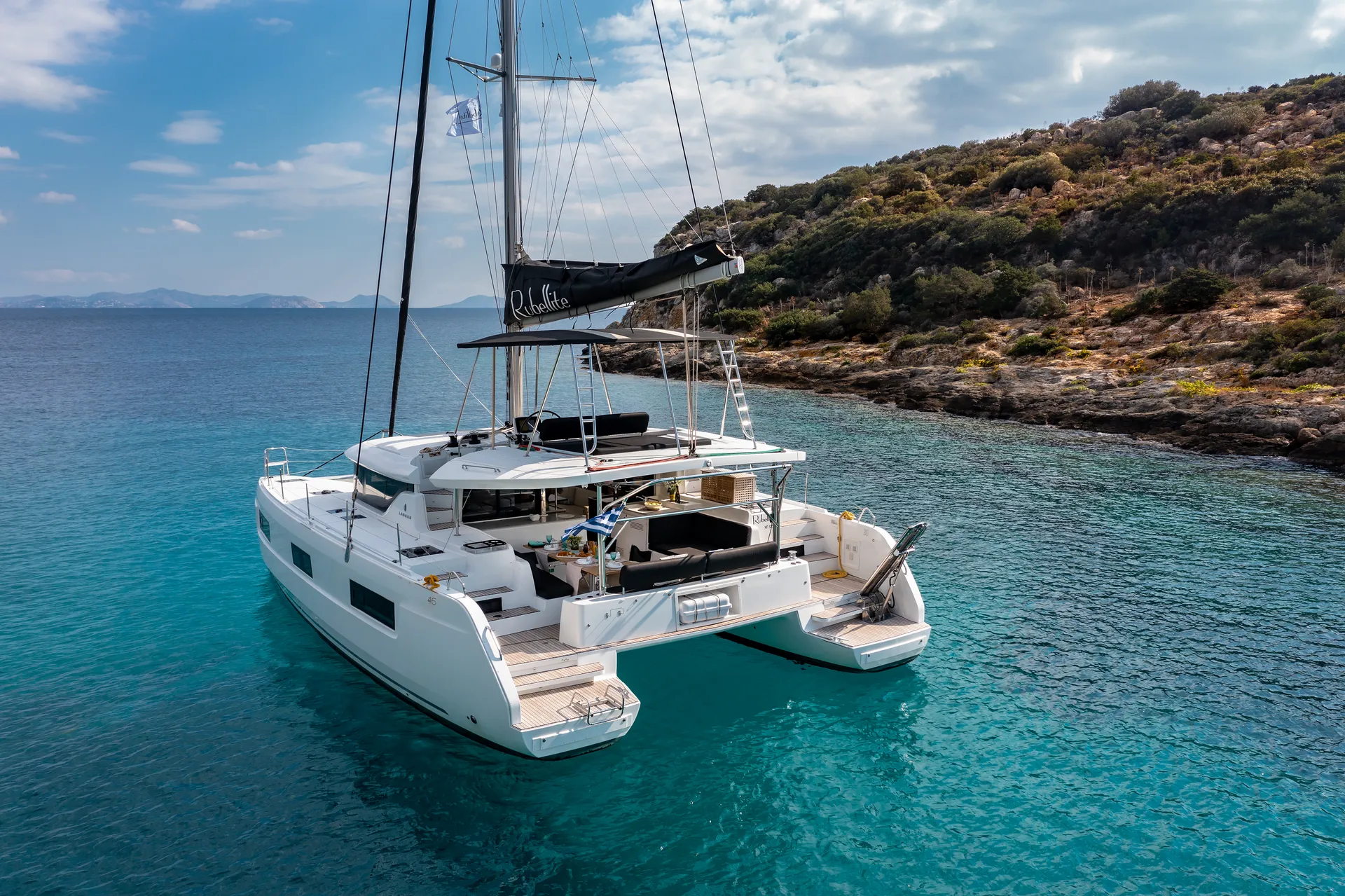 White Rock 36 speedboat with captain at helm cruising calm blue waters near Paros coastline with hills in background.