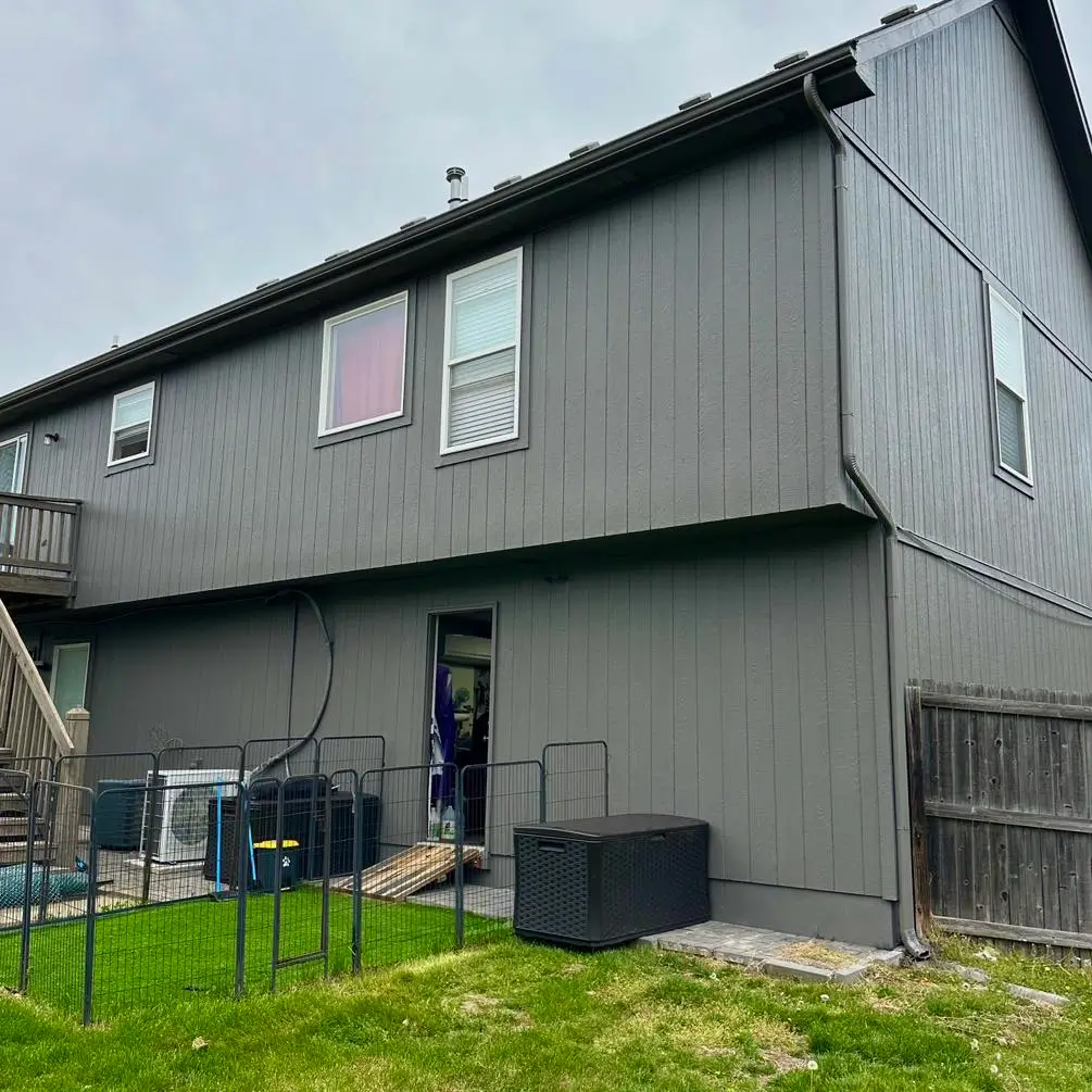 An image of a grey house showing newly repaired wood rot.