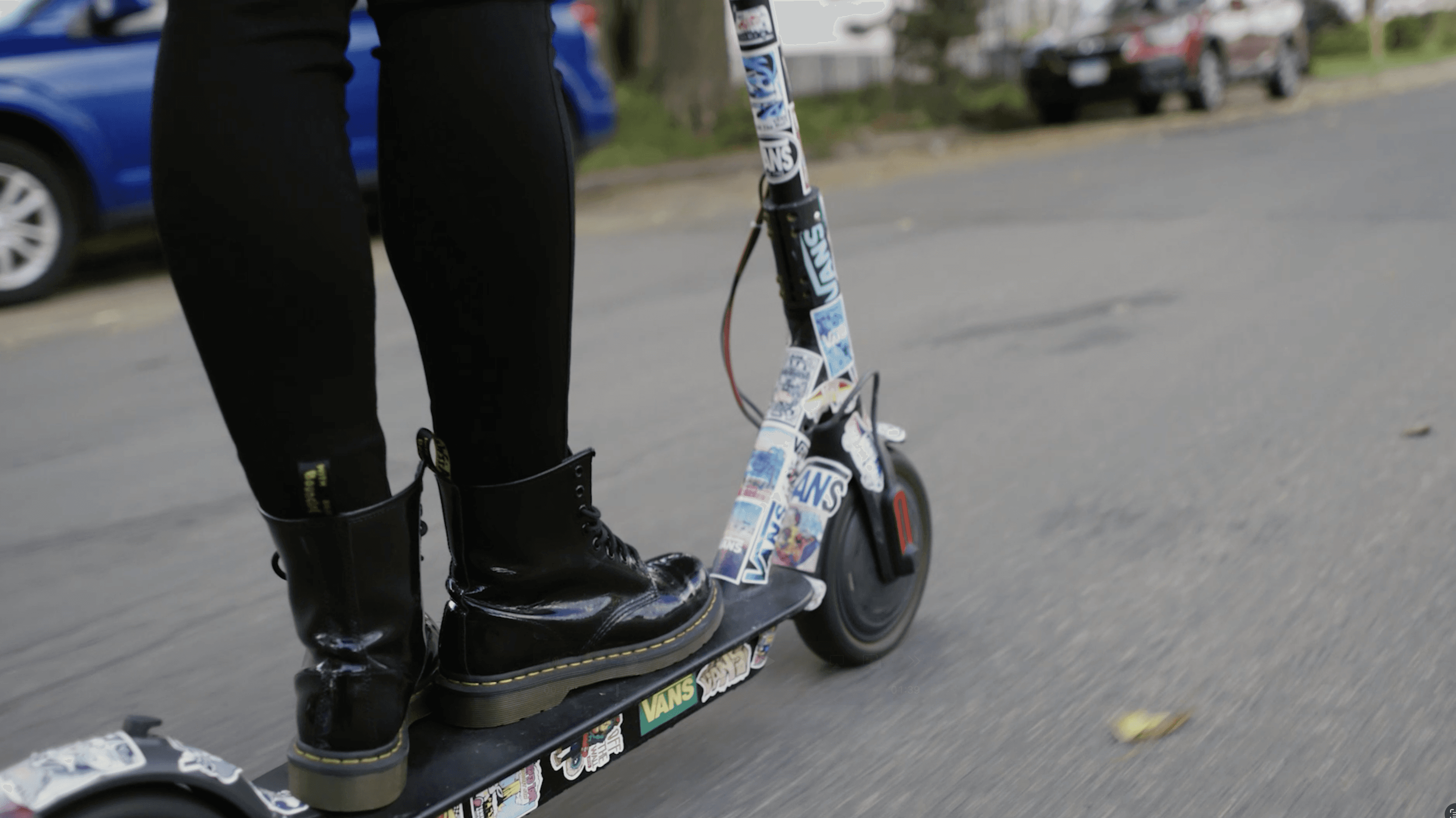 Close up of the woman's scooter, covered in neighborhood stickers