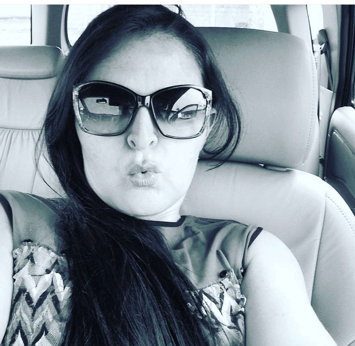 smiling woman wearing white and black pinstriped collared top