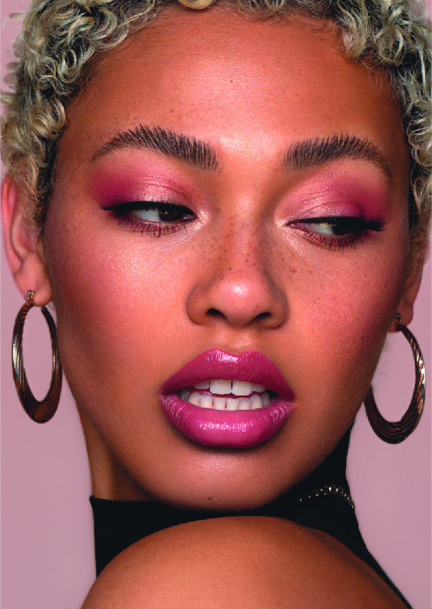 Image of female wearing pink eye makeup