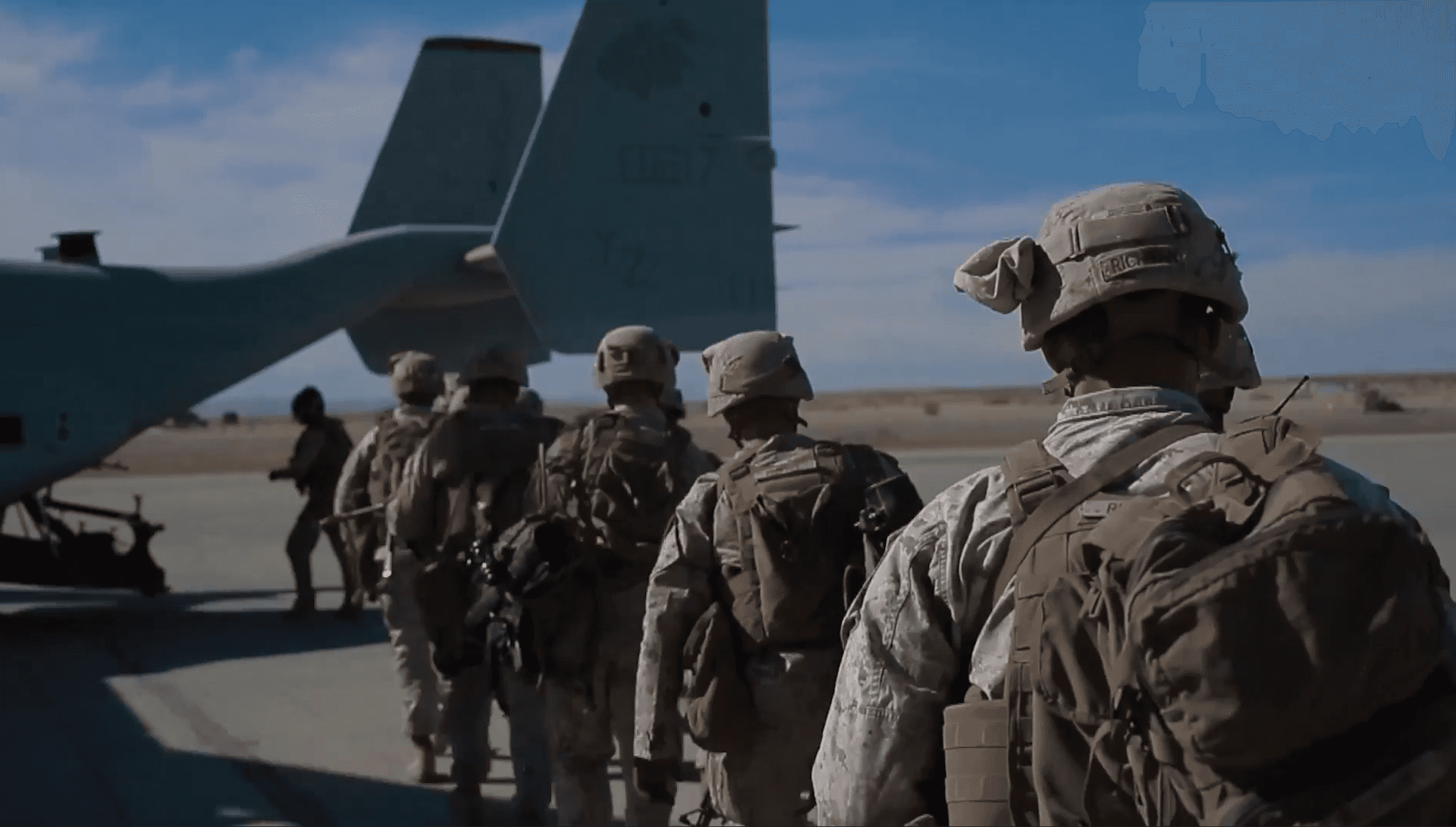 Group of uniformed soldiers walking toward a military aircraft on a runway—symbolizing defense operations, field deployment, or government readiness.