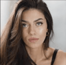 a man with a goatee smiles at the camera