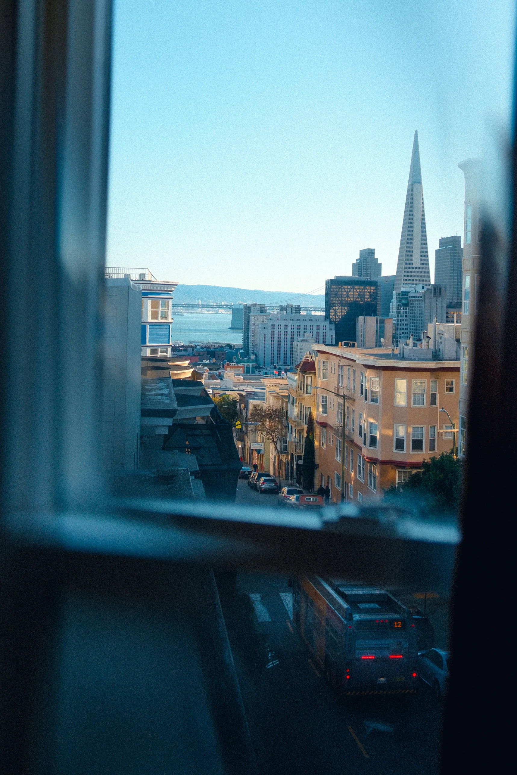 View of Faro city rooftops and church towers seen through a hotel window