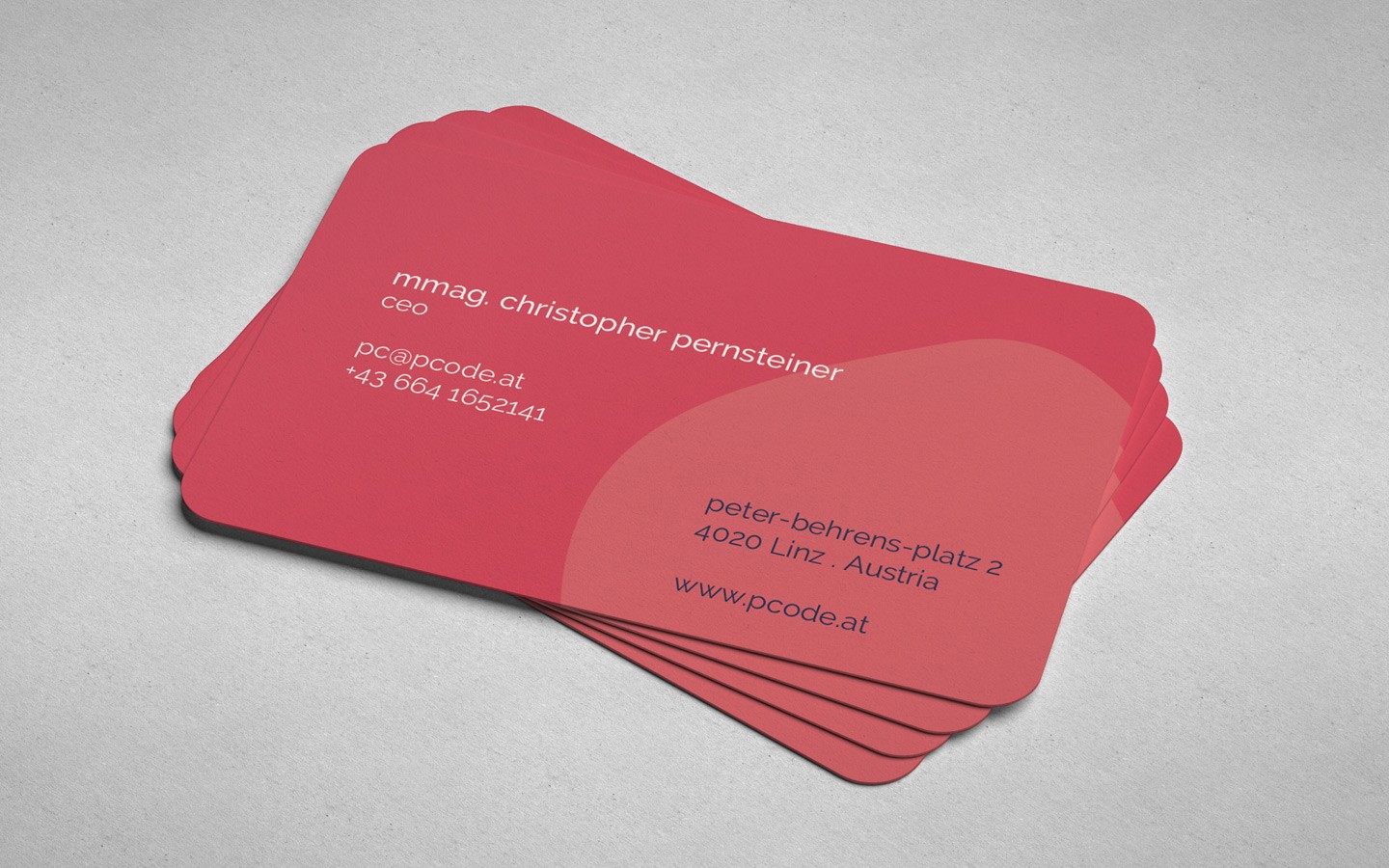 Stack of red business cards with rounded corners.