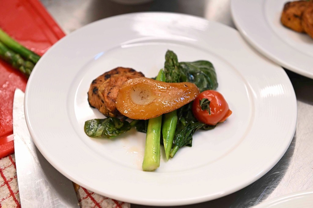 two glass of iced tea with some orange fruit around them